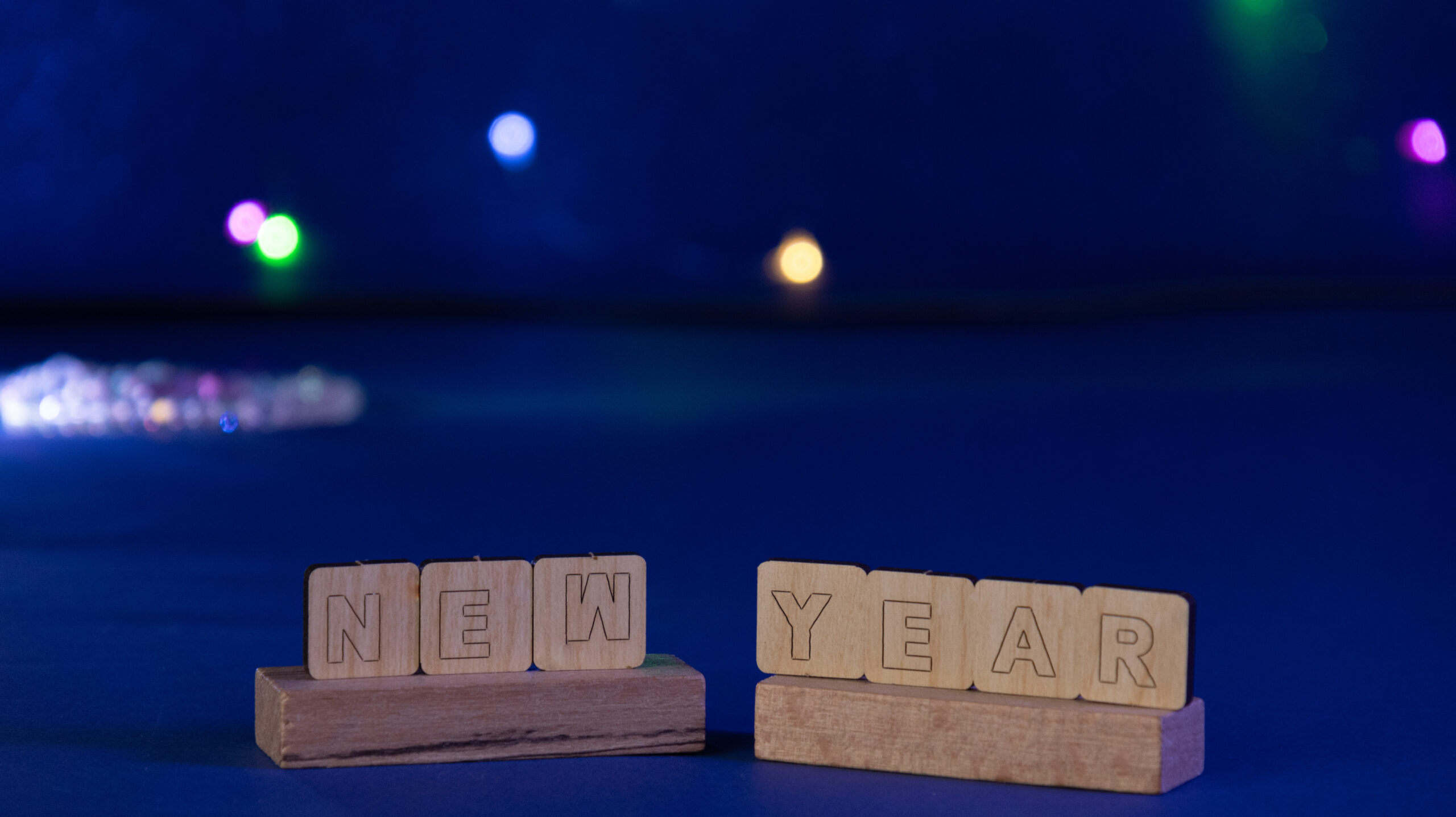 The word new year on wooden cubes-Backgrounds, Art of Photography, light background,